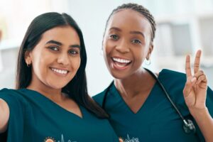 two people in medical uniforms smiling