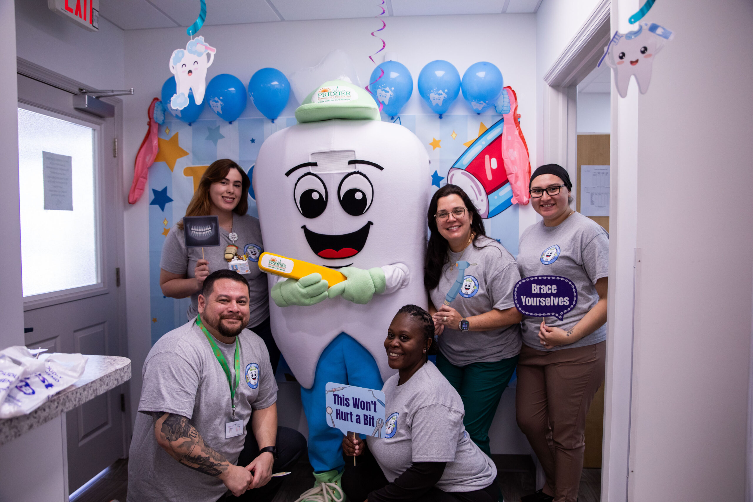The brush squad takes a break to take a picture with Dr. Flossy.